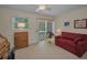 Bright bedroom with neutral walls, ceiling fan, and sliding door access to a balcony at 5115 S Jules Verne Ct, Tampa, FL 33611