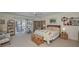 Bright bedroom featuring a ceiling fan, a large bed, and sliding glass doors to the outside at 5115 S Jules Verne Ct, Tampa, FL 33611