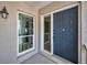 Inviting entryway with a stylish front door, a bright sidelight window offering a welcoming ambiance for guests at 5115 S Jules Verne Ct, Tampa, FL 33611