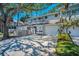 Townhouse exterior with a private balcony, garage, and mature tree in front yard at 5115 S Jules Verne Ct, Tampa, FL 33611
