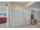 Hallway featuring a closet with louvered doors and views into two separate rooms at 5115 S Jules Verne Ct, Tampa, FL 33611