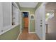 Hallway featuring unique architectural details, a built-in display case, and easy access to various rooms throughout the home at 5115 S Jules Verne Ct, Tampa, FL 33611