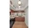 Bright kitchen area featuring brick floors and a view to the dining room at 5115 S Jules Verne Ct, Tampa, FL 33611