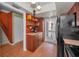 Kitchen featuring brick floors, wood cabinets, and view to staircase and backyard at 5115 S Jules Verne Ct, Tampa, FL 33611
