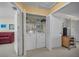 Hall closet featuring stacked washer and dryer with cleaning supplies and shelving at 5115 S Jules Verne Ct, Tampa, FL 33611