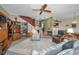 Inviting living room with a ceiling fan, bookshelves, a fireplace, and carpet floors at 5115 S Jules Verne Ct, Tampa, FL 33611