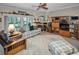 Cozy living room with comfortable seating, a ceiling fan, and a view of the outdoor patio through sliding glass doors at 5115 S Jules Verne Ct, Tampa, FL 33611