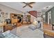 Spacious living room featuring plush seating, a ceiling fan, and a view into the hallway and dining area at 5115 S Jules Verne Ct, Tampa, FL 33611