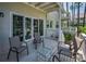 Outdoor porch has white railing, table, four chairs for relaxing and entertaining Gathering and guests at 5115 S Jules Verne Ct, Tampa, FL 33611