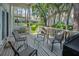 Outdoor porch has white railing, table, grill, four chairs for entertaining Gathering and guests at 5115 S Jules Verne Ct, Tampa, FL 33611