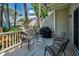 Outdoor porch has white railing, table, grill, four chairs for entertaining Gathering and guests at 5115 S Jules Verne Ct, Tampa, FL 33611