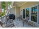 Outdoor porch has white railing, table, grill, four chairs for entertaining Gathering and guests at 5115 S Jules Verne Ct, Tampa, FL 33611