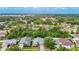 Overhead shot of a beautiful single Gathering house with mature trees, landscaped lawns, and neighborhood views at 5143 New Brittany Ln, Zephyrhills, FL 33541