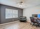 Small bedroom with a grey accent wall, window, and a desk and chair at 5143 New Brittany Ln, Zephyrhills, FL 33541