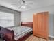 Bedroom with wood-look flooring, ceiling fan, and ample closet space at 5143 New Brittany Ln, Zephyrhills, FL 33541