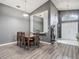 Dining room featuring a simple wooden table and chairs, with a view of the entryway and living area at 5143 New Brittany Ln, Zephyrhills, FL 33541