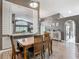 Dining room with a wooden table and an ornate mirror, offering a view of the living area at 5143 New Brittany Ln, Zephyrhills, FL 33541