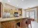 This kitchen features bar seating, granite countertops, and stainless steel appliances at 5143 New Brittany Ln, Zephyrhills, FL 33541