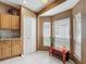 Bright eat-in kitchen features tile floors and corner windows for natural light at 5143 New Brittany Ln, Zephyrhills, FL 33541