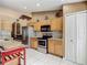 Kitchen has light cabinets, tile backsplash, stainless steel appliances, and granite countertops at 5143 New Brittany Ln, Zephyrhills, FL 33541