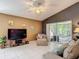Cozy living room with tiled floor, ceiling fan, and sliding doors to a screened porch with a hammock at 5143 New Brittany Ln, Zephyrhills, FL 33541