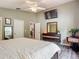 Main bedroom with a large bed, closet, ceiling fan, dresser, and desk at 5143 New Brittany Ln, Zephyrhills, FL 33541