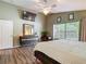 This is a main bedroom with a ceiling fan, large window, and a wooden dresser at 5143 New Brittany Ln, Zephyrhills, FL 33541