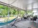 Relaxing screened patio with stylish seating and a backyard view at 5143 New Brittany Ln, Zephyrhills, FL 33541