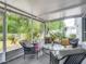 Enjoy outdoor living on this screened patio with comfortable seating and views at 5143 New Brittany Ln, Zephyrhills, FL 33541