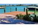 Dock with wooden planks, posts, and a boat; waterfront property in background at 530 59Th Ave, St Pete Beach, FL 33706