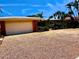 Single-story home with a gravel yard, well-maintained landscaping and an attached garage at 530 59Th Ave, St Pete Beach, FL 33706