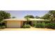 Charming single-story home featuring a white tile roof, well-manicured landscaping, and an attached two-car garage at 530 59Th Ave, St Pete Beach, FL 33706