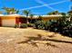 Charming home with a brick accent wall, mature landscaping, and a gravel driveway at 530 59Th Ave, St Pete Beach, FL 33706