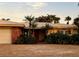 This home's front yard features a lush array of greenery, palm trees, and an eye-catching brick accent at 530 59Th Ave, St Pete Beach, FL 33706