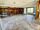 Open-concept living space with wood-look tile flooring, needs to be renovated at 530 59Th Ave, St Pete Beach, FL 33706