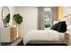 Stylish bedroom featuring a large bed, modern furniture, and a decorative plant at 6492 Top Hill Dr, New Port Richey, FL 34655