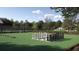Outdoor chess and cornhole area with manicured lawns, trees, and a playground, creating a fun space for recreation at 6492 Top Hill Dr, New Port Richey, FL 34655