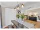 Modern dining room with sleek table, stylish lighting, and a view to the living area at 655 33Rd Ave N, St Petersburg, FL 33704