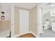 Hallway leading to bathroom with closet, hardwood floors, and fresh paint at 655 33Rd Ave N, St Petersburg, FL 33704