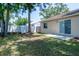 Backyard featuring a lawn, fence, and the back of the house with a sliding glass door at 6805 S Gabrielle St, Tampa, FL 33611