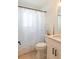 Well-lit bathroom with leaf patterned shower curtain, white vanity, and modern fixtures at 6805 S Gabrielle St, Tampa, FL 33611