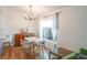 Cozy dining area with a modern chandelier, a dining table with chairs, and backyard views at 6805 S Gabrielle St, Tampa, FL 33611
