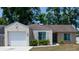 Charming single-story home with well-maintained landscaping, attached garage and neutral paint at 6805 S Gabrielle St, Tampa, FL 33611