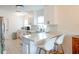Bright kitchen features white cabinetry, stainless steel appliances, and an island with counter seating at 6805 S Gabrielle St, Tampa, FL 33611