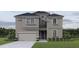Stunning two-story home with a neutral color scheme, manicured lawn, and attached garage at 720 W Peninsular St, Tampa, FL 33603