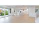Open-concept living room with natural light, hardwood floors, and access to the kitchen and outdoor lanai at 720 W Peninsular St, Tampa, FL 33603