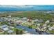 An aerial view of a charming home with canal access, lush greenery and waterfront views at 814 Seabreeze Dr, Ruskin, FL 33570
