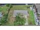 An aerial view shows a canal-front home with lush landscaping and a long driveway at 814 Seabreeze Dr, Ruskin, FL 33570