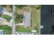 An aerial view showcasing the property, landscaping, roof, and proximity to nearby street at 814 Seabreeze Dr, Ruskin, FL 33570