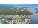 Aerial shot showcases the property and neighborhood within proximity to waterfront canal at 814 Seabreeze Dr, Ruskin, FL 33570
